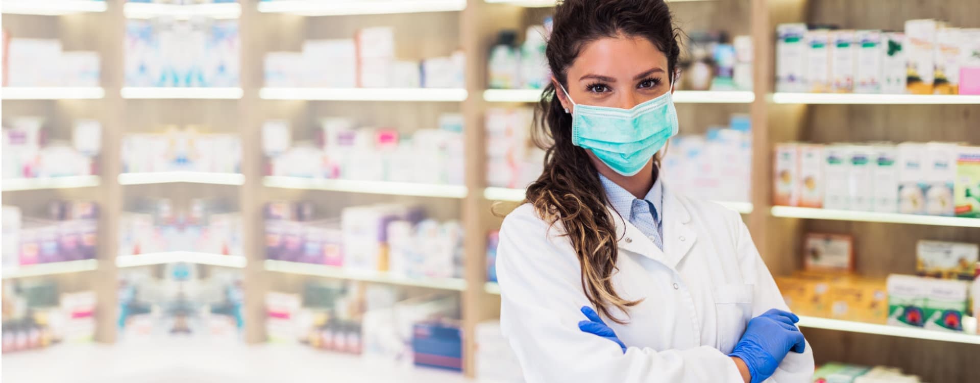 smiling pharmacist wearing a mask